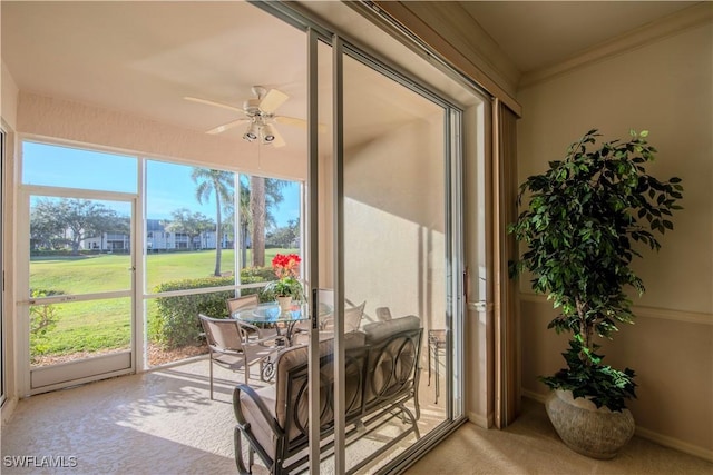 sunroom featuring ceiling fan