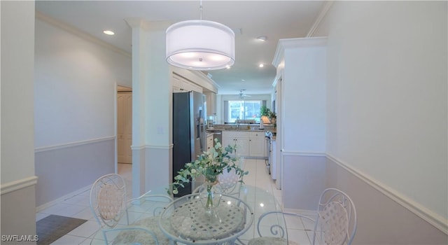 tiled dining area with sink and crown molding