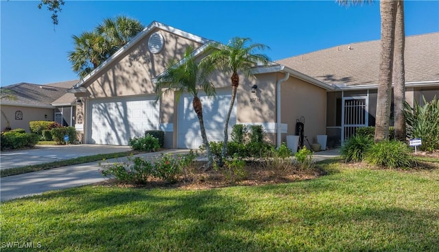 view of front of home with a garage and a front lawn