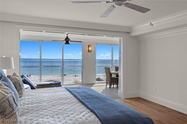 bedroom featuring access to outside, ornamental molding, light hardwood / wood-style floors, and a water view