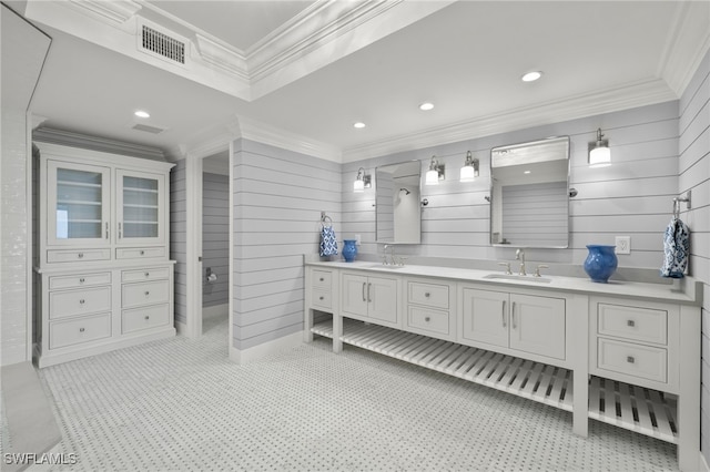 bathroom featuring ornamental molding and vanity