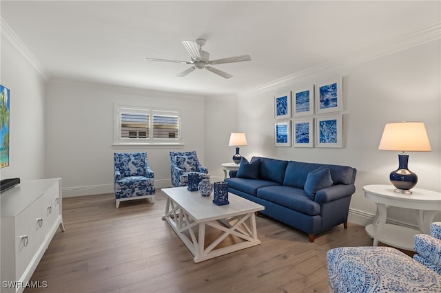 living room with ceiling fan, ornamental molding, and wood-type flooring