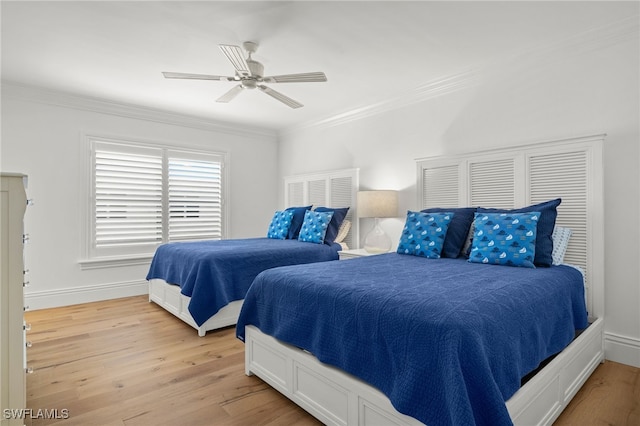 bedroom with crown molding, ceiling fan, and light wood-type flooring