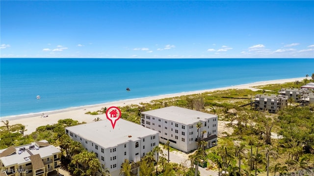 birds eye view of property with a view of the beach and a water view