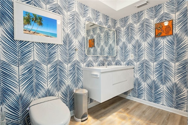 bathroom featuring wood-type flooring, tile walls, and toilet