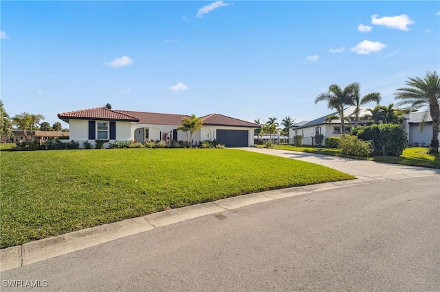 ranch-style home with a garage and a front yard