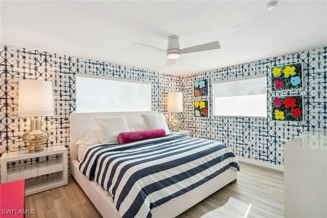 bedroom with light hardwood / wood-style floors and ceiling fan