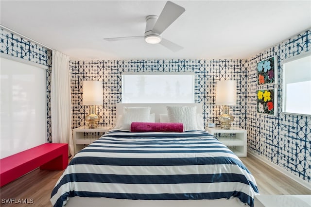 bedroom with wood-type flooring and ceiling fan