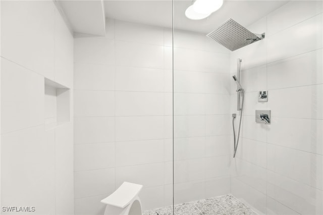 bathroom with tiled shower