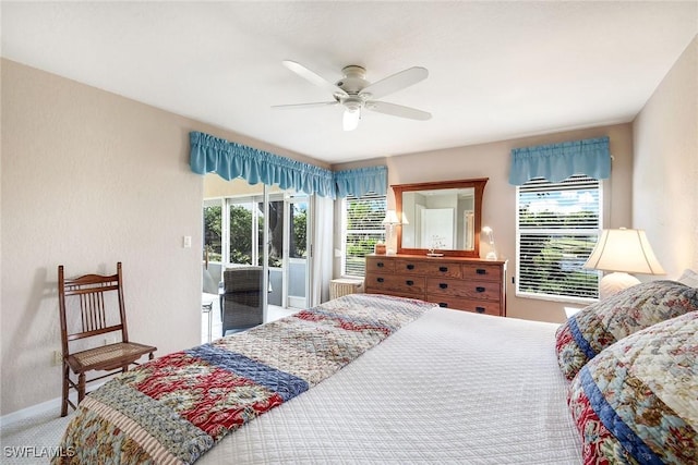 carpeted bedroom with ceiling fan, access to exterior, and multiple windows