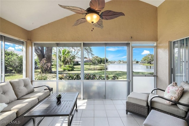 sunroom featuring a water view, ceiling fan, and vaulted ceiling