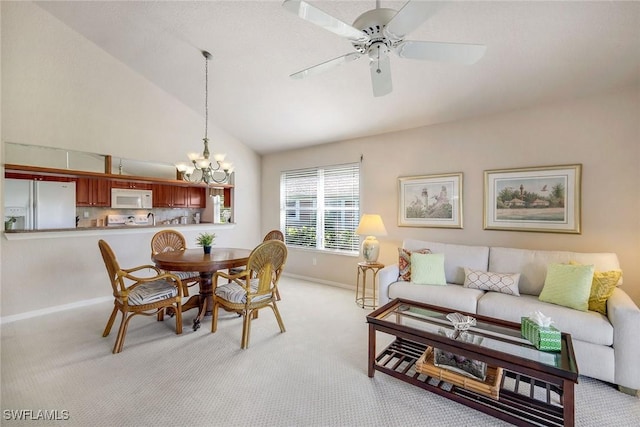 dining area featuring high vaulted ceiling, ceiling fan with notable chandelier, and light carpet