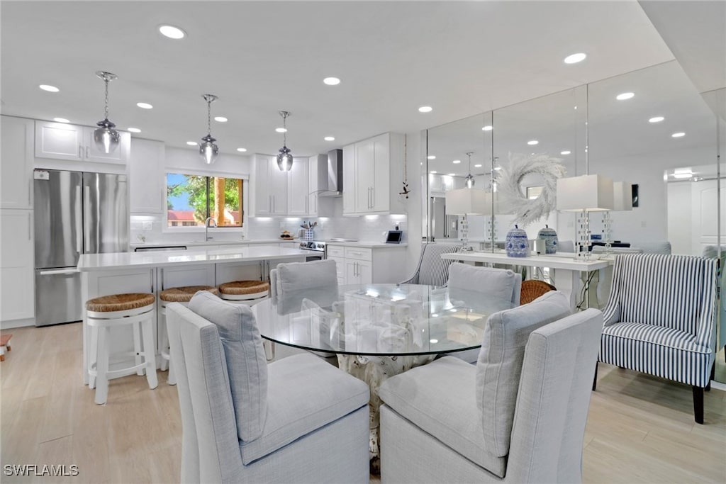 dining space featuring sink and light wood-type flooring