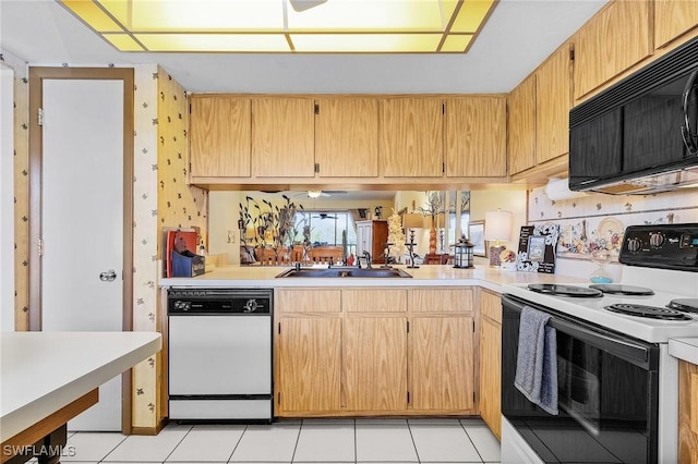 kitchen with black microwave, electric range, a sink, light countertops, and dishwasher