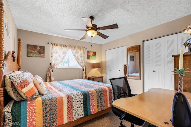 bedroom featuring ceiling fan, a textured ceiling, and two closets