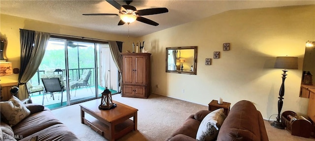 living area with lofted ceiling, light carpet, ceiling fan, and a textured ceiling