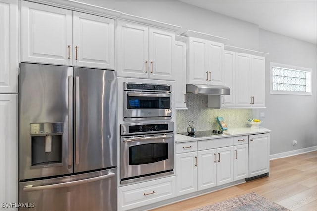 kitchen with backsplash, stainless steel appliances, light hardwood / wood-style flooring, and white cabinets