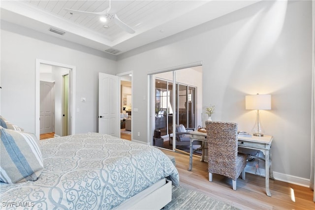 bedroom with ceiling fan, hardwood / wood-style floors, wood ceiling, and a tray ceiling