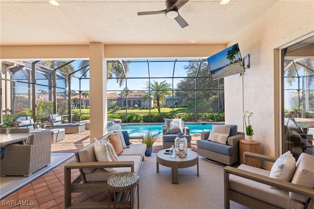 view of patio featuring ceiling fan, an outdoor hangout area, and glass enclosure