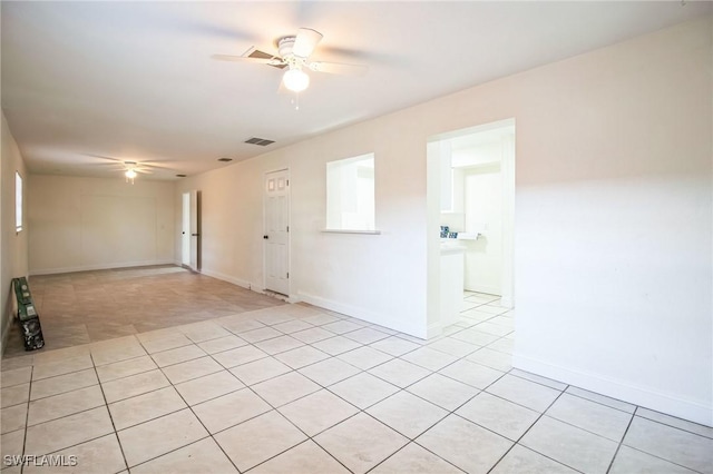 unfurnished room featuring ceiling fan and light tile patterned flooring