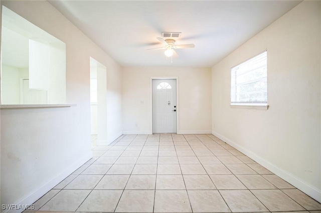 tiled entrance foyer featuring ceiling fan