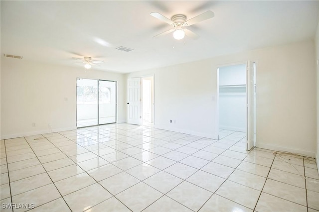 unfurnished room with light tile patterned floors and ceiling fan