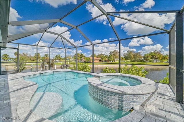 view of pool with a patio area, an in ground hot tub, a water view, and glass enclosure