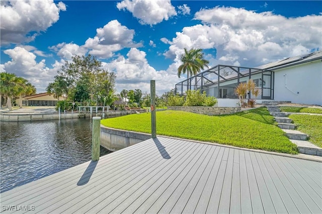 dock area featuring a water view, a lanai, and a yard