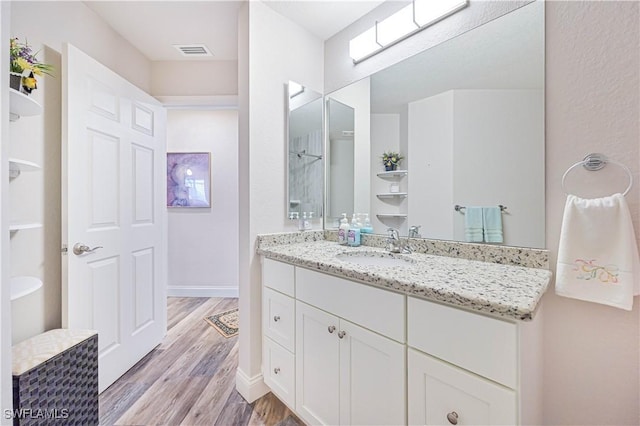 bathroom with wood-type flooring and vanity