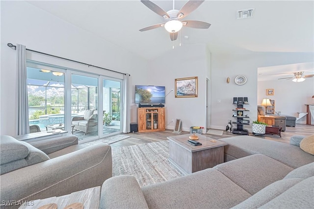 living room featuring ceiling fan, high vaulted ceiling, and light wood-type flooring