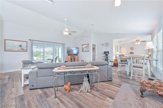 living room with light hardwood / wood-style flooring, high vaulted ceiling, and ceiling fan