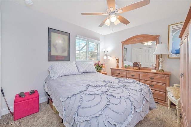 bedroom featuring light carpet and ceiling fan