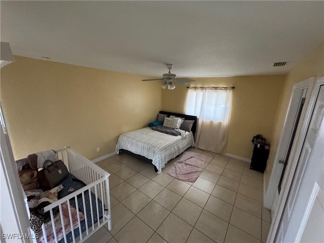 tiled bedroom with ceiling fan