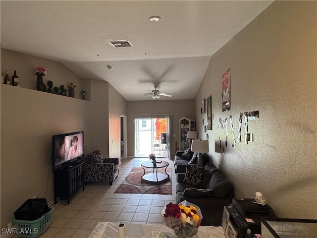 living room with vaulted ceiling, ceiling fan, and light tile patterned floors