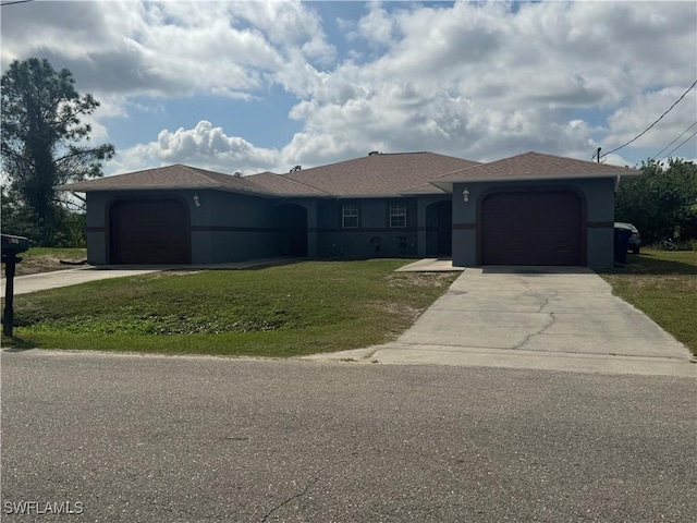 ranch-style house featuring a front lawn and a garage