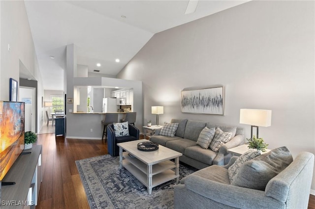 living room featuring dark hardwood / wood-style flooring and high vaulted ceiling