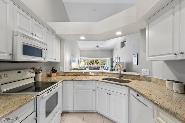 kitchen featuring sink, white appliances, light tile patterned floors, light stone counters, and white cabinets