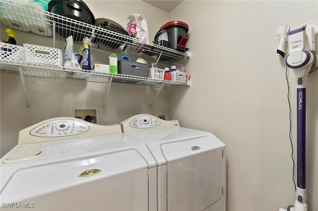 clothes washing area with washing machine and clothes dryer