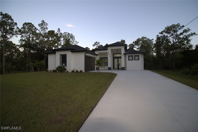 view of front facade with a garage and a front lawn