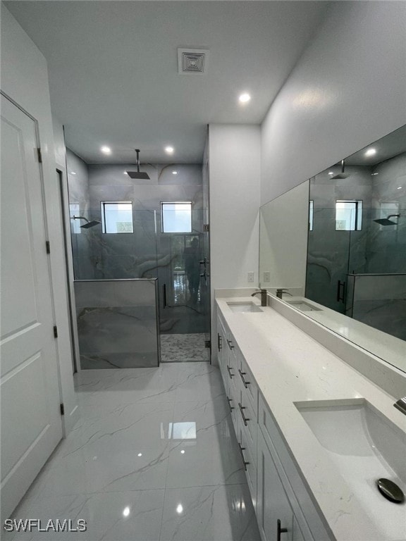 bathroom with vanity and a shower with shower door