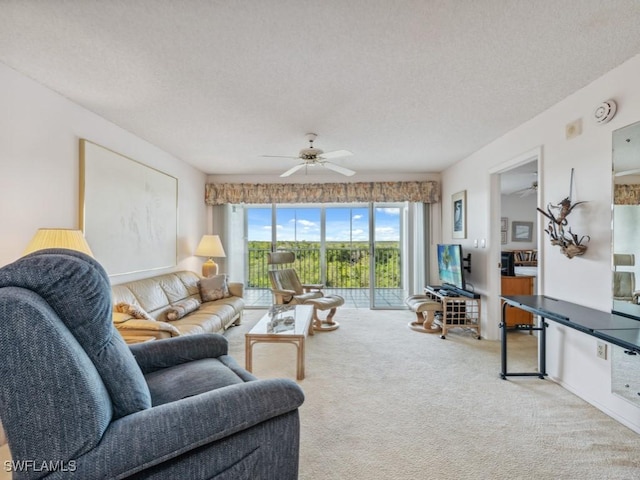 living room featuring light carpet, a textured ceiling, and ceiling fan