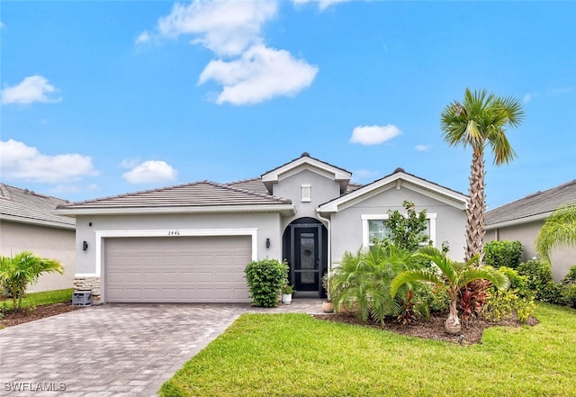 view of front of property with a garage and a front lawn