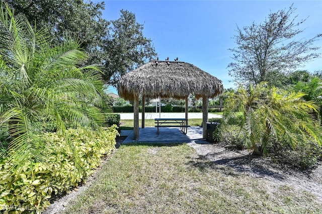 view of property's community featuring a gazebo, a patio area, and a water view