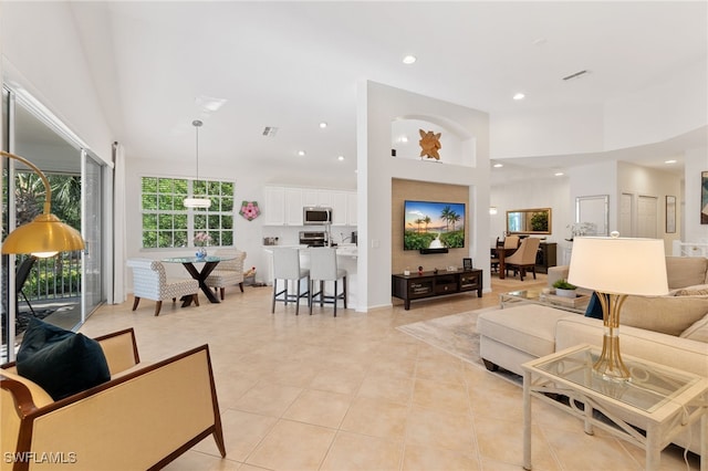 tiled living room with a towering ceiling