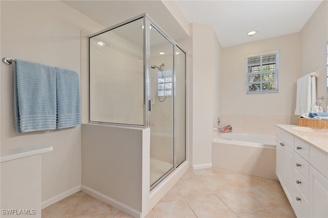 bathroom with tile patterned flooring, vanity, and independent shower and bath