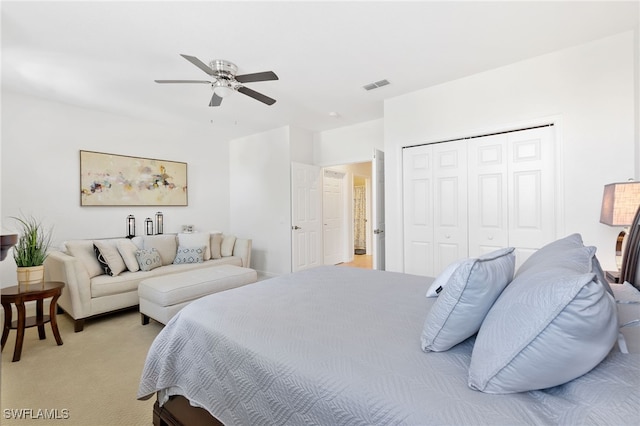 carpeted bedroom featuring a closet and ceiling fan