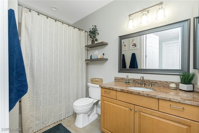 bathroom featuring vanity, tile patterned floors, and toilet