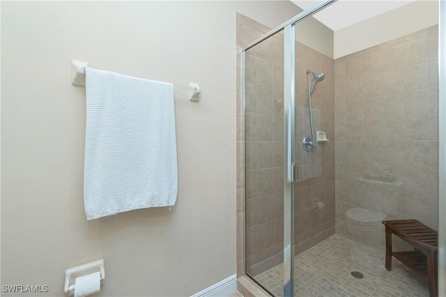 bathroom with an enclosed shower and toilet