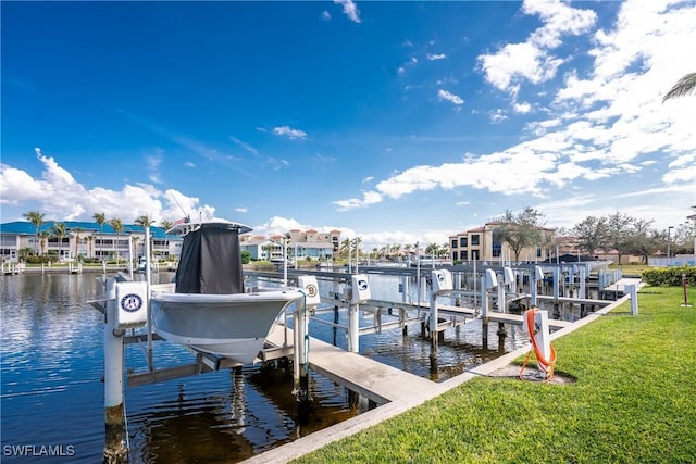 dock area with a water view and a yard