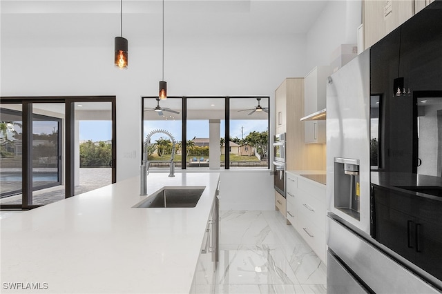 kitchen with hanging light fixtures, sink, and ceiling fan